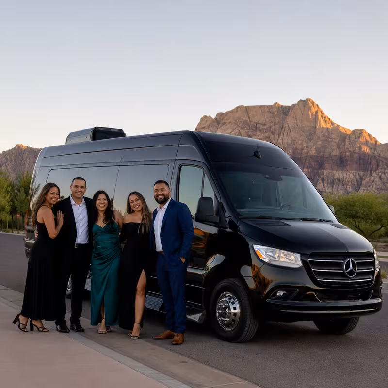 Group beside a Mercedes Sprinter limo from the Las Vegas fleet at the beach
