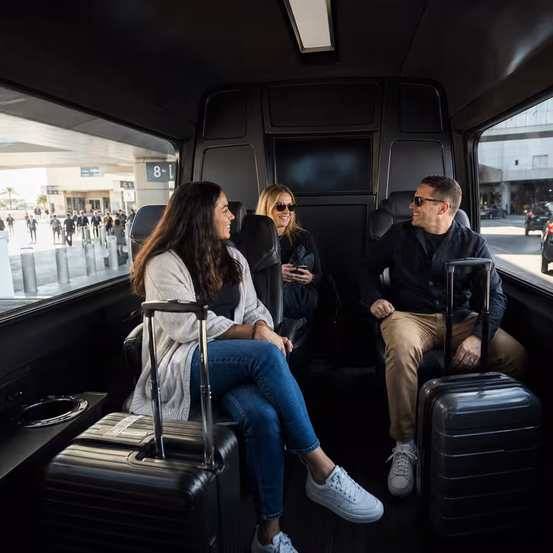 Passengers loading luggage while boarding an Las Vegas group shuttle