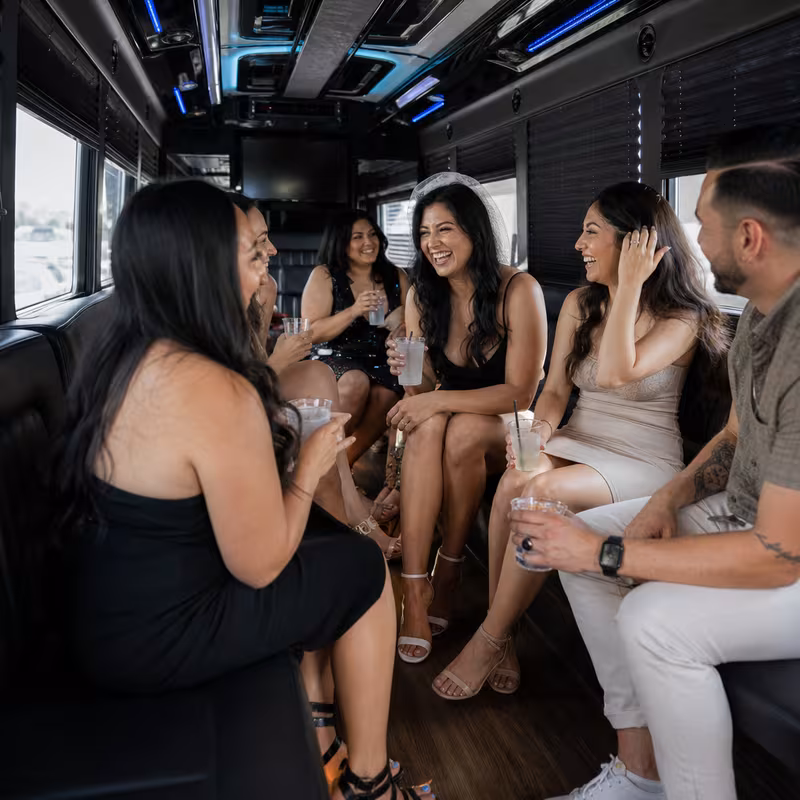 Party bus interior with wraparound leather seating and LED lighting in Las Vegas