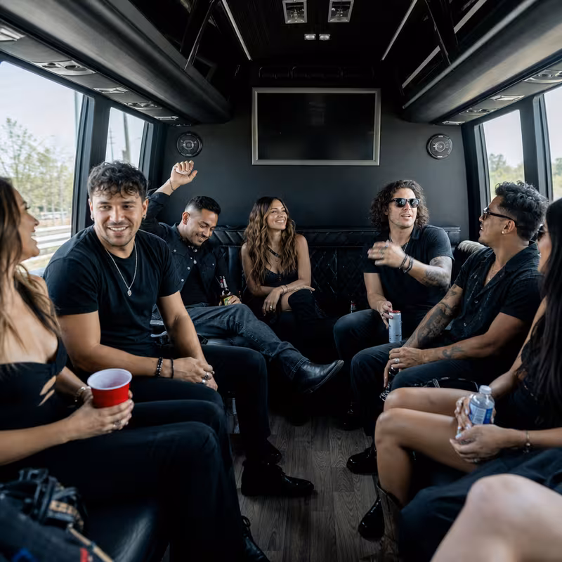 Group boarding a white charter bus for Concert Transportation transportation in Las Vegas