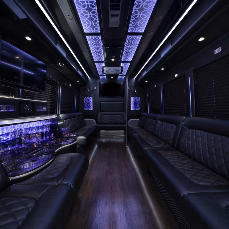 Party bus interior with wraparound leather seating and LED lighting in Las Vegas