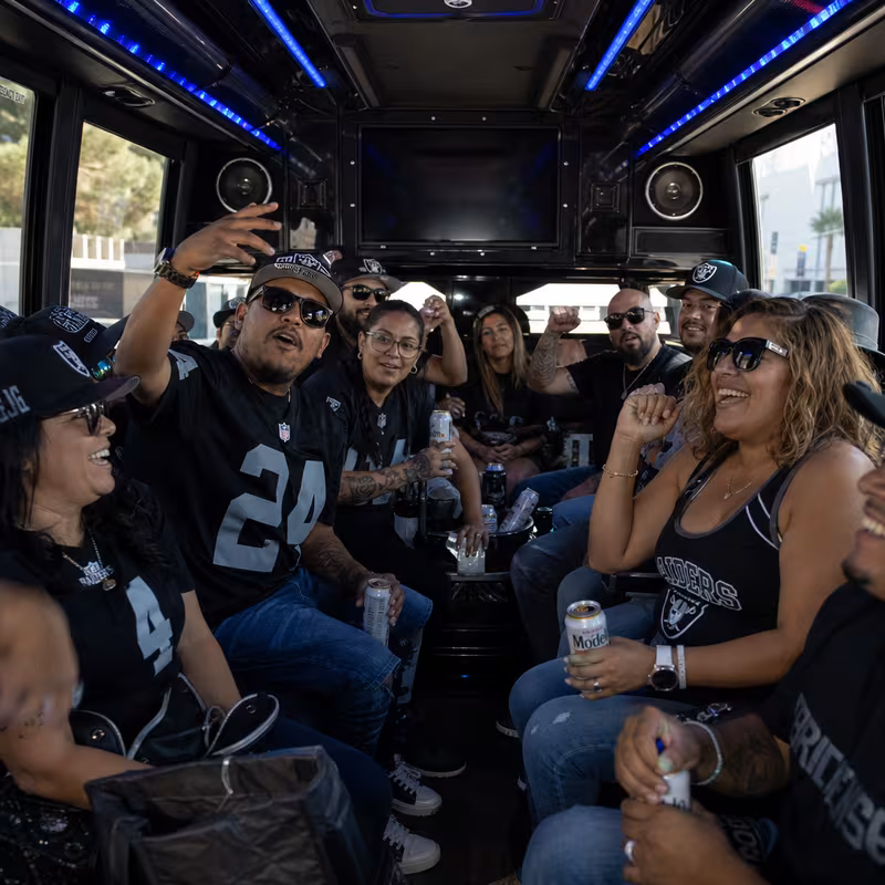 Group boarding a white charter bus for Sporting Event Transportation transportation in Las Vegas