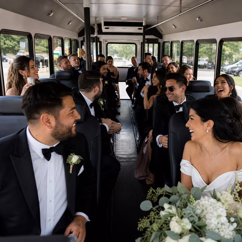 Group boarding a white charter bus for Wedding Transportation transportation in Las Vegas