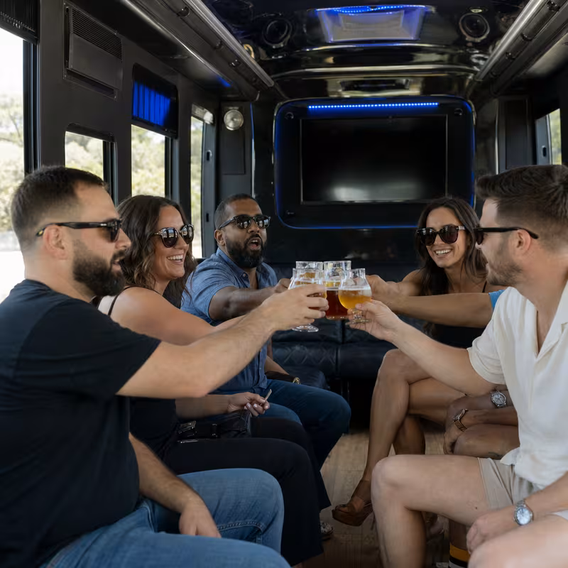 Group boarding a white charter bus for Winery & Brewery Tour Transportation transportation in Las Vegas